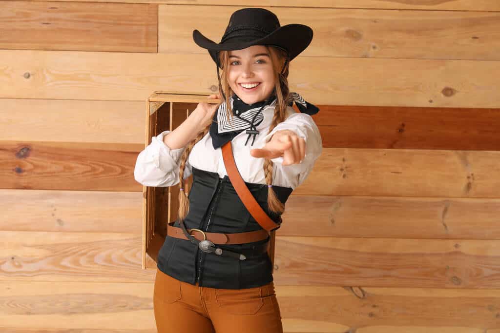 A young woman in a cowgirl outfit.